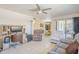Comfortable living room with tile floors, ceiling fan, and open access to the kitchen and dining area at 8320 E Nido Ave, Mesa, AZ 85209