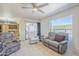 Bright and airy living room with a ceiling fan, tile floors, and comfortable seating at 8320 E Nido Ave, Mesa, AZ 85209