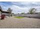Wide angle shot of the backyard with gravel, patio, playset, grass and desert landscaping at 903 W Barrow Dr, Chandler, AZ 85225