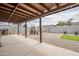 Large backyard with covered patio, gravel landscaping, basketball hoop, playground, and a small patch of green grass at 903 W Barrow Dr, Chandler, AZ 85225