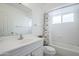 Bright bathroom with a shower and tub combination, window, and a single sink at 903 W Barrow Dr, Chandler, AZ 85225