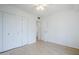 Bright bedroom featuring neutral walls, light-colored hardwood floors, and double closet at 903 W Barrow Dr, Chandler, AZ 85225