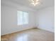 A well lit bedroom with hardwood floors, bright white walls, and a large window at 903 W Barrow Dr, Chandler, AZ 85225