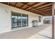 Covered patio featuring concrete floor, ceiling beams, a stainless steel grill and sliding glass doors at 903 W Barrow Dr, Chandler, AZ 85225