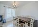 Bright dining room features a modern chandelier and a wood table set for six at 903 W Barrow Dr, Chandler, AZ 85225