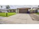 Exterior of a brick home featuring a two-car garage, lush green lawn, and a paved driveway at 903 W Barrow Dr, Chandler, AZ 85225
