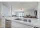 Modern kitchen with stainless steel sink and stone countertops, adjacent to an open living space at 903 W Barrow Dr, Chandler, AZ 85225