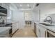 Bright kitchen boasts sleek stainless steel appliances and modern white cabinetry with stone countertops at 903 W Barrow Dr, Chandler, AZ 85225