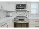 Close-up of a modern kitchen with stainless steel appliances, white counters, and ample lighting at 903 W Barrow Dr, Chandler, AZ 85225