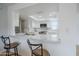 Bright kitchen features stainless steel appliances, sleek stone countertops, and barstool seating at 903 W Barrow Dr, Chandler, AZ 85225