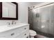 Bathroom featuring a white vanity with carrara marble countertops, a toilet, and a glass-enclosed shower at 907 W Laguna Dr, Tempe, AZ 85282