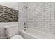 Bathroom featuring a white subway tile, a toilet, and a bathtub with shower head at 907 W Laguna Dr, Tempe, AZ 85282
