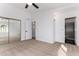 Spacious bedroom with mirrored closet doors and an ensuite bathroom featuring a glass enclosed shower at 907 W Laguna Dr, Tempe, AZ 85282