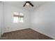 Bedroom featuring plush carpet, a ceiling fan, and a window for natural light at 907 W Laguna Dr, Tempe, AZ 85282