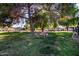 Scenic common area featuring trees, picnic tables and barbecue grills at 907 W Laguna Dr, Tempe, AZ 85282