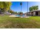 Beautiful community pool with a brick cabana area surrounded by green grass and palm trees at 907 W Laguna Dr, Tempe, AZ 85282