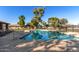 Beautiful community pool with a brick cabana area surrounded by green grass and palm trees at 907 W Laguna Dr, Tempe, AZ 85282