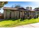 View of the home featuring a manicured lawn and brick privacy fence at 907 W Laguna Dr, Tempe, AZ 85282