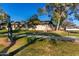 Charming single-story homes surround a green common area with mature shade trees at 907 W Laguna Dr, Tempe, AZ 85282