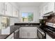 Updated kitchen featuring stainless appliances, granite counters, and ample storage space at 907 W Laguna Dr, Tempe, AZ 85282