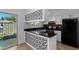 Kitchen with tile flooring, black countertops and backsplash, and white cabinets at 907 W Laguna Dr, Tempe, AZ 85282