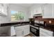 Well-lit kitchen with stainless steel appliances, granite countertops, and modern cabinetry at 907 W Laguna Dr, Tempe, AZ 85282