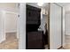 Convenient laundry area featuring a stacked washer and dryer, plus extra shelf storage in a hallway at 907 W Laguna Dr, Tempe, AZ 85282