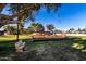 Well-maintained community playground featuring swings, slides and climbing equipment at 907 W Laguna Dr, Tempe, AZ 85282