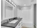 This bathroom has a shower and tub combo and a vanity with a granite countertop at 9230 N 82Nd Ln, Peoria, AZ 85345