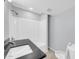 This bathroom has a shower and tub combo, a black countertop and an undermount sink at 9230 N 82Nd Ln, Peoria, AZ 85345
