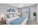 Bedroom features soft blue accents, a ceiling fan, and neutral walls at 9230 N 82Nd Ln, Peoria, AZ 85345