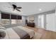 Well-lit bedroom with a ceiling fan, wooden floors, and a large dresser at 9230 N 82Nd Ln, Peoria, AZ 85345