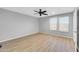 Large bedroom with modern ceiling fan, wood-look floors, and plenty of natural light at 9230 N 82Nd Ln, Peoria, AZ 85345
