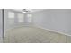 Bedroom with neutral paint, tile floors, and two large windows at 9230 N 82Nd Ln, Peoria, AZ 85345