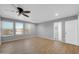 Bright bedroom with recessed lighting, ceiling fan and wood-look floors with an ensuite bathroom at 9230 N 82Nd Ln, Peoria, AZ 85345