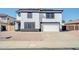 Two-story home featuring a two-car garage, low maintenance landscaping, and black and white trim at 9230 N 82Nd Ln, Peoria, AZ 85345