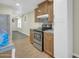 This home features a kitchen with wooden cabinets, stainless steel oven, and tiled backsplash at 9230 N 82Nd Ln, Peoria, AZ 85345