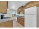 This kitchen features marble countertops, wooden cabinets, and a stainless steel refrigerator at 9230 N 82Nd Ln, Peoria, AZ 85345