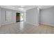 This room features tan tile flooring, neutral paint, and access to the backyard at 9230 N 82Nd Ln, Peoria, AZ 85345