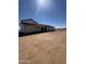 Ranch home with long porch and expansive dirt lot at 11142 E Copper Dust Trl, Florence, AZ 85132