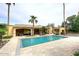 Resort style backyard featuring a pool, travertine patio and mature landscaping at 10365 E Paradise Dr, Scottsdale, AZ 85260