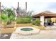Outdoor space featuring a built-in jacuzzi, outdoor dining area, and mature landscaping at 10365 E Paradise Dr, Scottsdale, AZ 85260