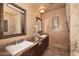 Elegant bathroom featuring dual sinks, granite countertops, and decorative accents at 10365 E Paradise Dr, Scottsdale, AZ 85260