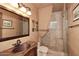 Elegant bathroom featuring a tiled shower and a stylish vanity at 10365 E Paradise Dr, Scottsdale, AZ 85260