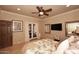 Bright bedroom with a view of doors and a flat screen television at 10365 E Paradise Dr, Scottsdale, AZ 85260