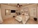 Cozy bedroom with a plush bed, ceiling fan, and ample natural light at 10365 E Paradise Dr, Scottsdale, AZ 85260