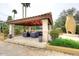 Outdoor covered cabana with stone columns, travertine floor, stucco fireplace and comfortable seating at 10365 E Paradise Dr, Scottsdale, AZ 85260