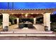 Cozy covered patio with comfortable seating and ambient lighting, ideal for evening gatherings at 10365 E Paradise Dr, Scottsdale, AZ 85260