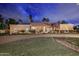 Stunning home featuring desert landscaping, a brick driveway, and unique arched windows under a clay tile roof at 10365 E Paradise Dr, Scottsdale, AZ 85260