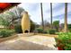 A unique stucco outdoor fireplace sits on a travertine tiled patio at 10365 E Paradise Dr, Scottsdale, AZ 85260